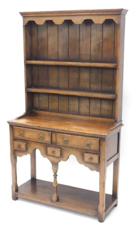 A Titchmarsh and Goodwin small oak dresser, the raised back with two shelves, the base with an arrangement of two long and three short drawers on turned supports with pot board, 162cm high, 91cm wide, 36cm deep.