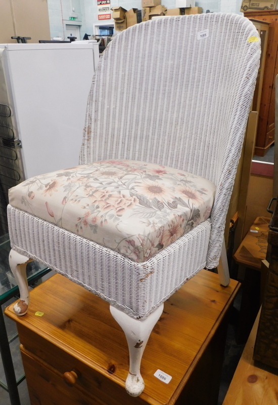 A Lloyd Loom style tub chair.