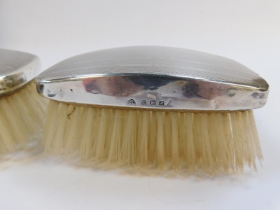 A cased pair of silver backed hair brushes, each with engine turned domed top, Adie Bros Ltd, Birmingham 1949. - 4