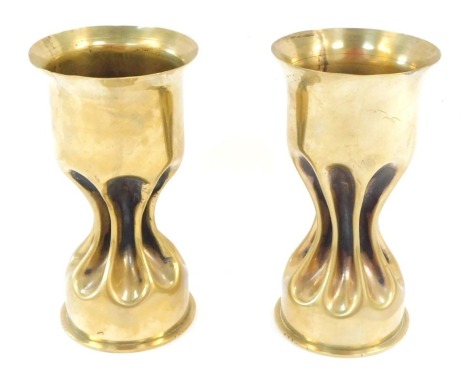 Trench Art. A pair of WWI brass shell cases converted to vases, with fluted and capped stem, dated 1917 and 1918 to undersides, 18cm high.