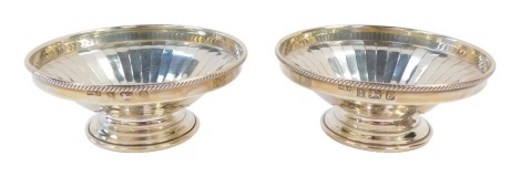 A pair of Elizabeth II silver sweetmeat dishes, each with gadrooned border and fluted decoration on a stepped foot, Moody & Archer, Birmingham 1979, 4 1/2oz.