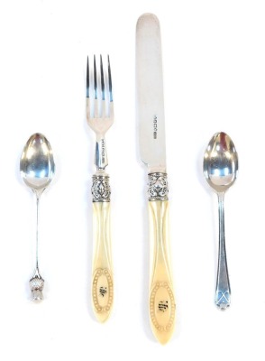 A small group of silver wares, comprising a pair of silver and ivory handled knives and forks, the ivory handles with beaded detailing and bearing the initial H, with silver ferrules, Elkington & Co, Sheffield 1890, together with a silver golfing teaspoon