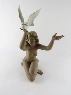 A Lladro matt porcelain figure of a nude lady, modelled kneeling holding aloft a dove, no 3559, printed and impressed marks, 53cm high. (AF) - 5