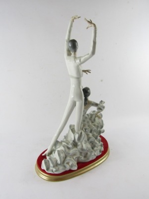 A Lladro porcelain figure group of flamenco dancers, depicting a man, and woman in a polka dot dress, impressed and printed marks, on a gold finish and velvet cushion base, 51cm high. - 3