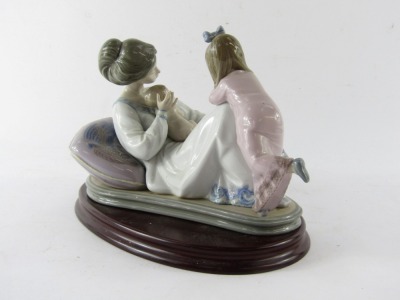 A Lladro porcelain figure group depicting mother and baby with child, no 1606, printed and impressed marks, on an oval wooden base, 20cm high, 23cm wide. - 2