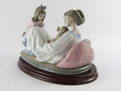 A Lladro porcelain figure group depicting mother and baby with child, no 1606, printed and impressed marks, on an oval wooden base, 20cm high, 23cm wide. - 4