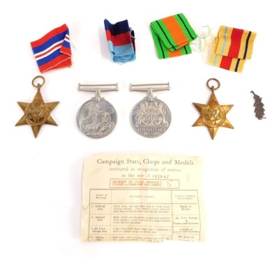 A group of WWII medals, comprising The Africa Star, The 1939-1945 Star, The Defence Medal, and War Medal with oak leaf clasp, with ribbons, and compliment slip from the Under Secretary of State for War.