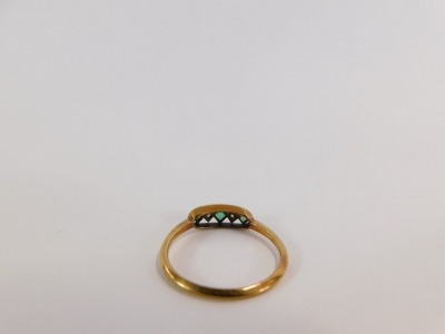 A 18ct gold Art Deco dress ring, with oval panel set with three spandrels each set with square cut stone, comprising three emeralds and two diamonds, in a platinum setting, on a yellow metal band, size S, 2.4g all in. - 2