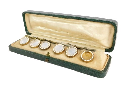 A Victorian cased collar set, with mother of pearl and white enamel detailing on a gilt finish, in a fitted case. (one AF).