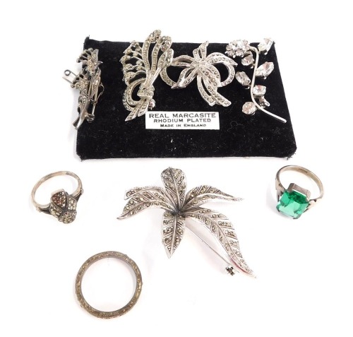 A group of silver and other marcasite set jewellery, comprising a silver and marcasite bow dress ring, a silver and marcasite tulips brooch, four paste stone set brooches, a silver and green stone paste set dress ring, and a silver and white paste stone e