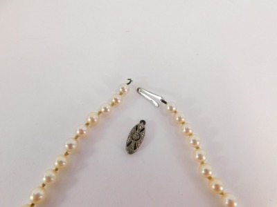 A string of Ciro cultured pearl beads, each on string strand, graduated with a white gold clasp, stamped 9ct, 50cm long. (AF) - 2