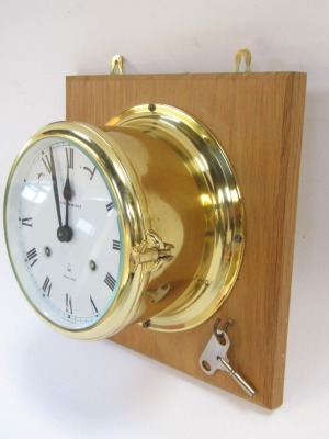 A Royal Mariner ship's wall clock, in brass case with white dial and Roman numerals, dated 1881, with clock key, 23cm x 23cm frame, dial 12cm diameter. - 3