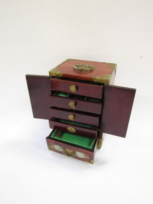 An early 20thC Chinese table cabinet, in stained wood with brass mounts and carved imitation jade panels, with two door opening to reveal four drawers, above a frieze drawer, raised on bracket feet, 28cm high, 18.5cm wide, 14cm deep. - 2