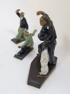 Three Mudmen figures of Oriental figures in pose, each with a blue and green glazed finish, the largest 23cm high. - 3