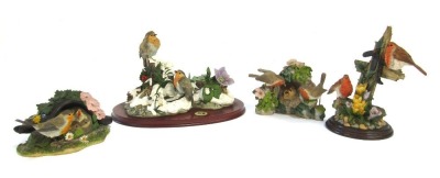 Four Danbury Mint and other figure groups, comprising Danbury Mint Feeding Time by Anne Richmond, 14cm high, Country Artist pair of Robins with Crocus, 21cm high, A First Snow by Anne Richmond, Robin figure group on wooden plinth base, 32cm wide, and Afte