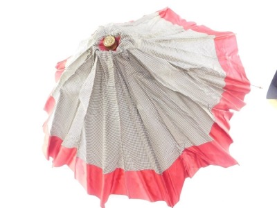 A 1920's/1930's Growy parasol, with brass ends and collar, and black gingham and red fabric, 55cm long. - 2