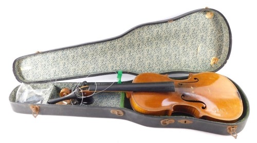 An early 20thC violin, with copy of Stradivarius, Berlin label, with two piece back, scroll end, ebonised knops and interior label, overall 59cm long, cased. (AF)