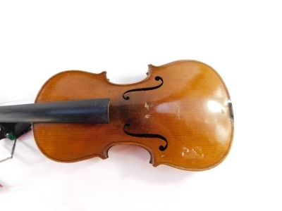 An early 20thC violin, with copy of Stradivarius, Berlin label, with two piece back, scroll end, ebonised knops and interior label, overall 59cm long, cased. (AF) - 3