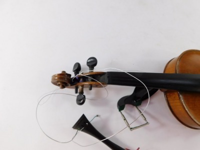 An early 20thC violin, with copy of Stradivarius, Berlin label, with two piece back, scroll end, ebonised knops and interior label, overall 59cm long, cased. (AF) - 4