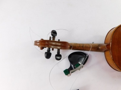 An early 20thC violin, with copy of Stradivarius, Berlin label, with two piece back, scroll end, ebonised knops and interior label, overall 59cm long, cased. (AF) - 6