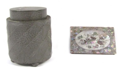 A Civic pewter tea caddy and cover, No 1178, with hammered spiral fluted decoration, 12cm high, together with a Chinese wooden panel with mother of pearl inlay, depicting a duck and water lilies, 10.5cm x 7.5cm. (2)