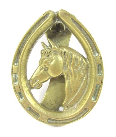 A brass horse shoe and horse head door knocker, 12cm high.