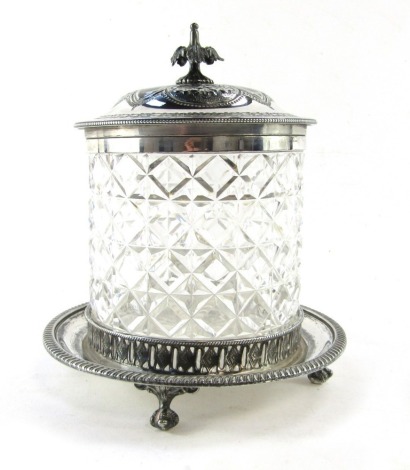 A Victorian cut glass biscuit barrel, with an embossed and engraved floral hinged lid, and stand, 22cm high.