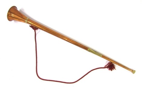 A copper coaching and brass bound post horn, 86cm long, with red tie handle.