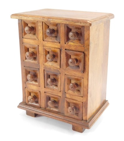 A hardwood spice chest, with twelve individual drawers, on four block feet, 30cm high, 24cm wide, 16cm deep.