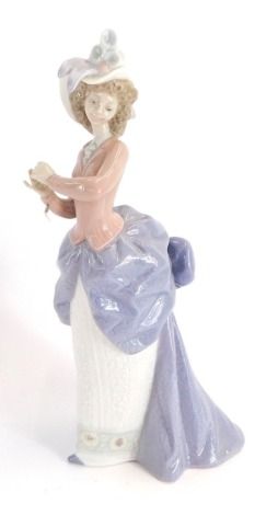 A LLadro porcelain figure of a lady in evening dress, clapping hands, numbered 5685, 20cm high.