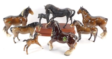 A group of horse figures, comprising a Royal Doulton Black Beauty and foal, on a raised base, a Melba ware shire horse, two Beswick shire horses, and three smaller Beswick horses. (7)