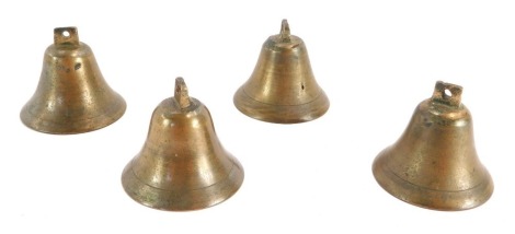 Four miniature bronze bells, each in a different key.