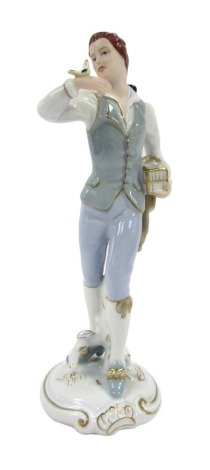 A Royal Dux Continental porcelain figure of a gentleman, in waistcoat, with bird, with Royal Dux pink triangle stamped to underside, 26.5cm high.