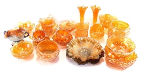 A group of carnival glass, comprising mainly orange vases and pudding dishes, some darkened purple effect vases, etc. (2 trays)