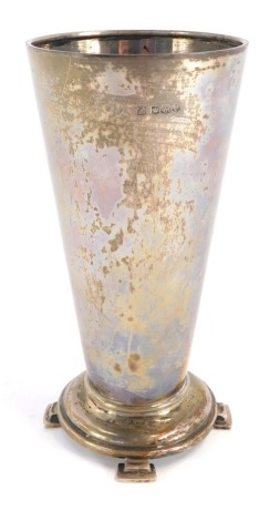 A George V silver trumpet vase, on circular foot with four two section feet, Sheffield 1934, 8½oz, 17cm high.