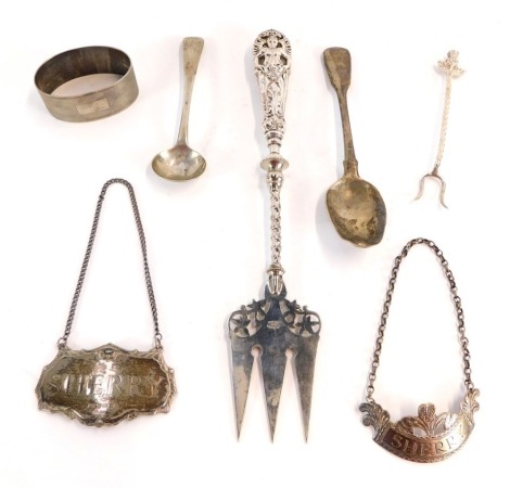 A group of silver and white metal cutlery items, comprising a German white metal three prong fork, with embossed handle of cherub and feathers, marked German silver, an early 19thC silver toddy spoon, fiddle pattern, bearing the emblem G, a George V engin