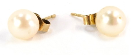 A pair of 9ct gold pearl studs, each with butterfly backs, 2.3g all in.