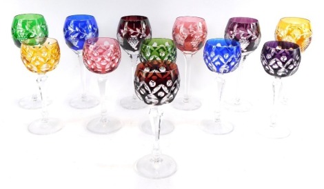 A set of six fluted coloured hock glasses, with faceted stems, 22cm high and six further wine glasses, with floral and vine engraving, 19cm high. (12)