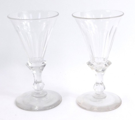 A pair of Victorian cut wine glasses, each with a fluted trumpet shaped bowl, over an octagonal baluster stem, and conical foot, 12cm high.