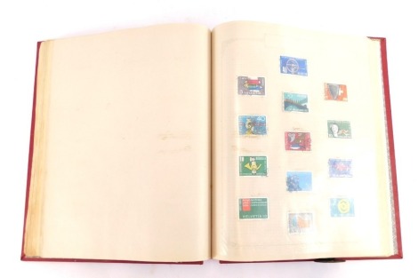 Philately. A world stamp album, containing GB GV-EII commemoratives and definitives, Empire and Commonwealth and world stamps.