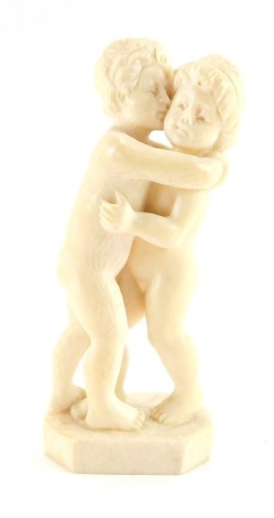 A late 19thC European ivory figure group, of two children in standing embrace, on a shaped base, 10cm high.