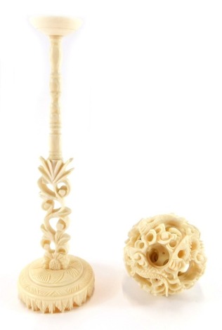 A late 19th/early 20thC Chinese ivory puzzle ball, with carved interwoven puzzle, on stand, 18cm high.