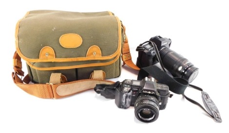 A group of camera equipment, comprising a Minolta 7000 camera, a camera care systems carry bag, a canvas carry bag, a Cannon EOS 620 and Cannon Zoom lens, 7T-210mm. (a quantity)