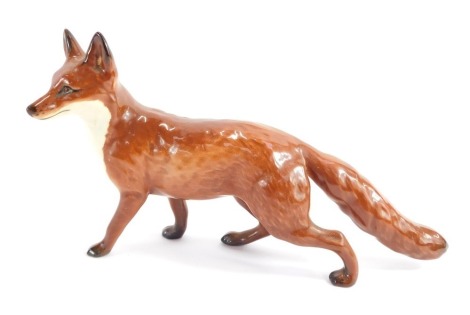 A Beswick pottery model of a fox, printed mark, 22cm wide.