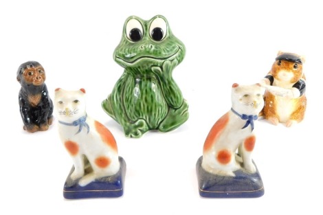 A group of pottery figures, comprising a pair of Staffordshire cats, a Sylvac frog, a John Beswick mouse with playing cards, and a modern John Beswick chimpanzee. (5)