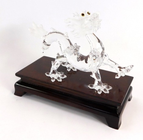 A Swarvoski crystal figure of a Chinese dragon, on wooden base, 12 high, boxed.