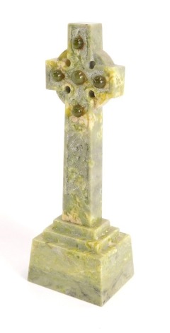 A Connemara marble Celtic cross, with beaded detailing, raised on a stepped, rectangular base, 12cm high.