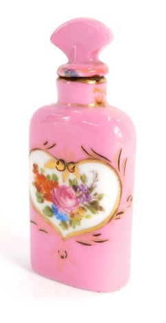 A continental porcelain scent bottle, on a pink ground with heart shaped panel, painted with floral sprays, 7.5cm high.