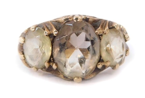 A 9ct gold dress ring, set with three citrines, in claw setting with scroll design shoulders, ring size L, 3.7g all in.