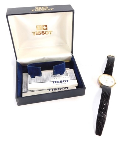 A Tissot 9ct gold gentleman's wristwatch, with silvered finish dial and date aperture, on a black leather strap, in a Tissot box, the dial 3cm diameter, 22g all in.